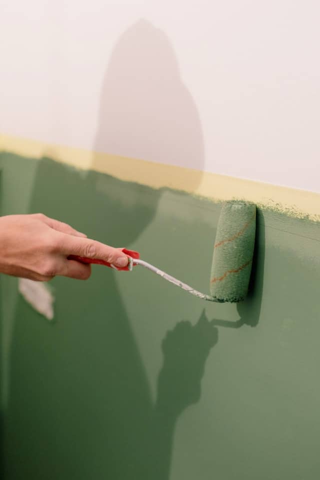 person painting wall