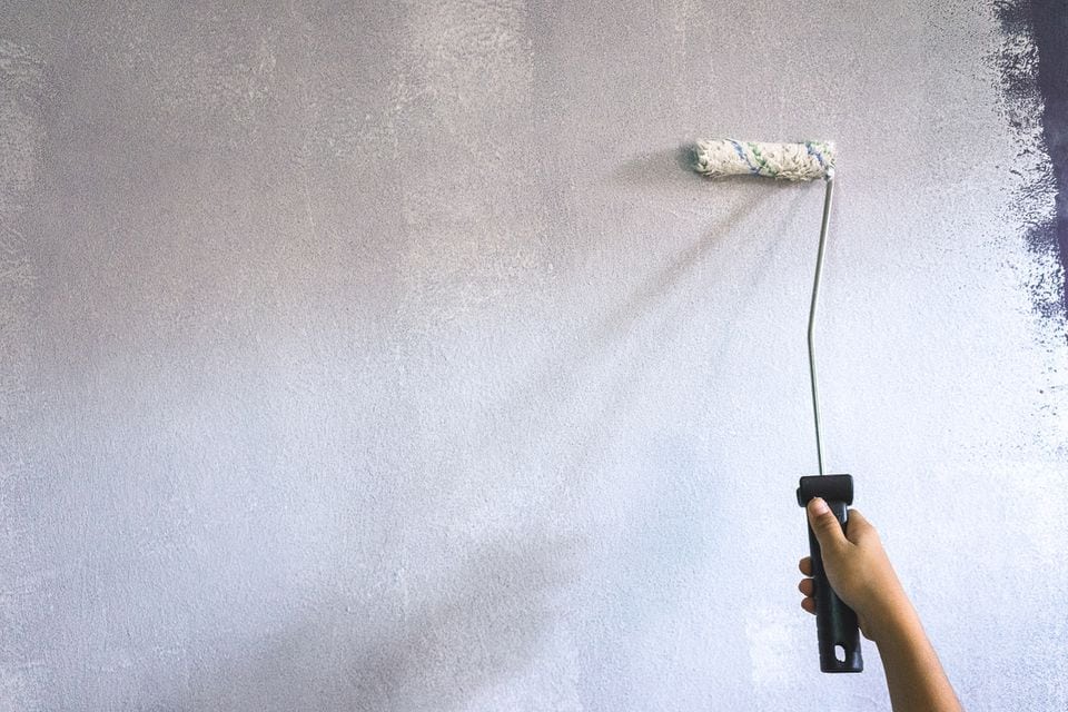 applying primer on wall